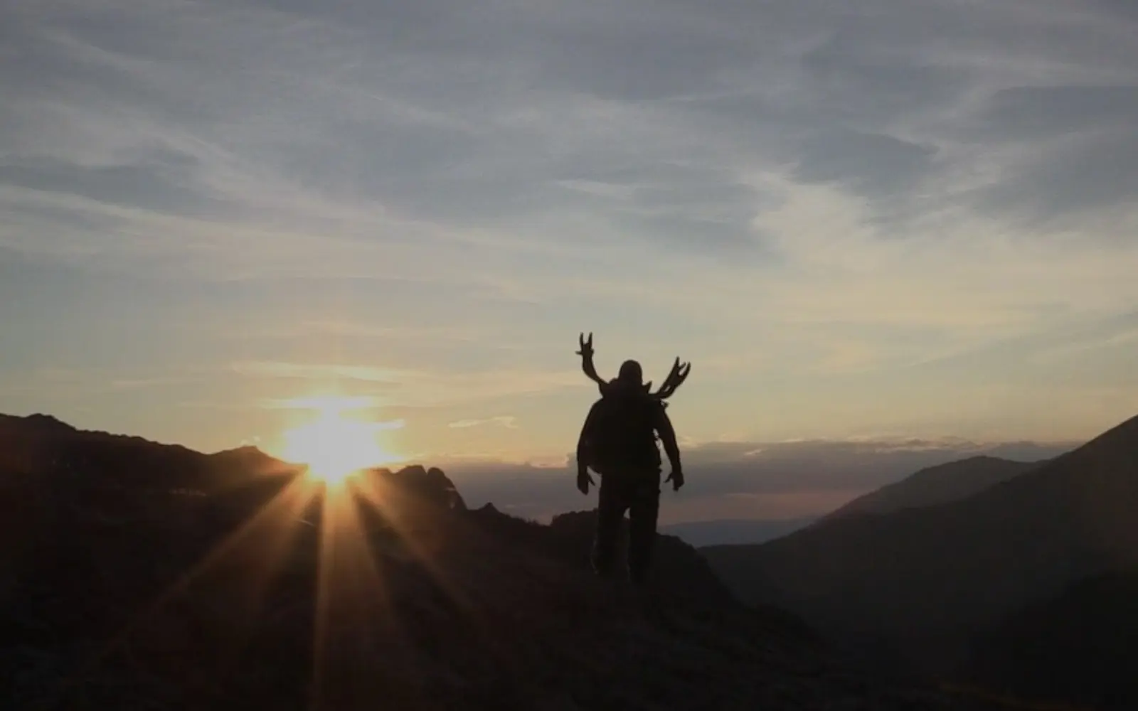 Someone standing in front of a sunset