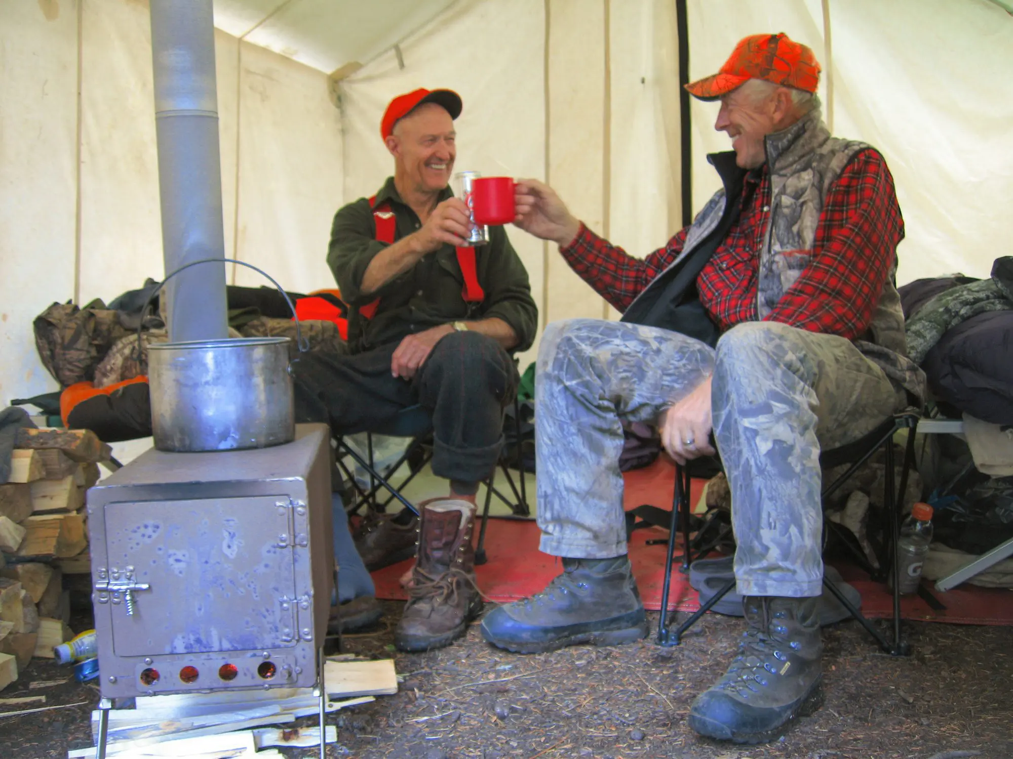 George Bettas and a fellow hunter enjoying coffee around the stove