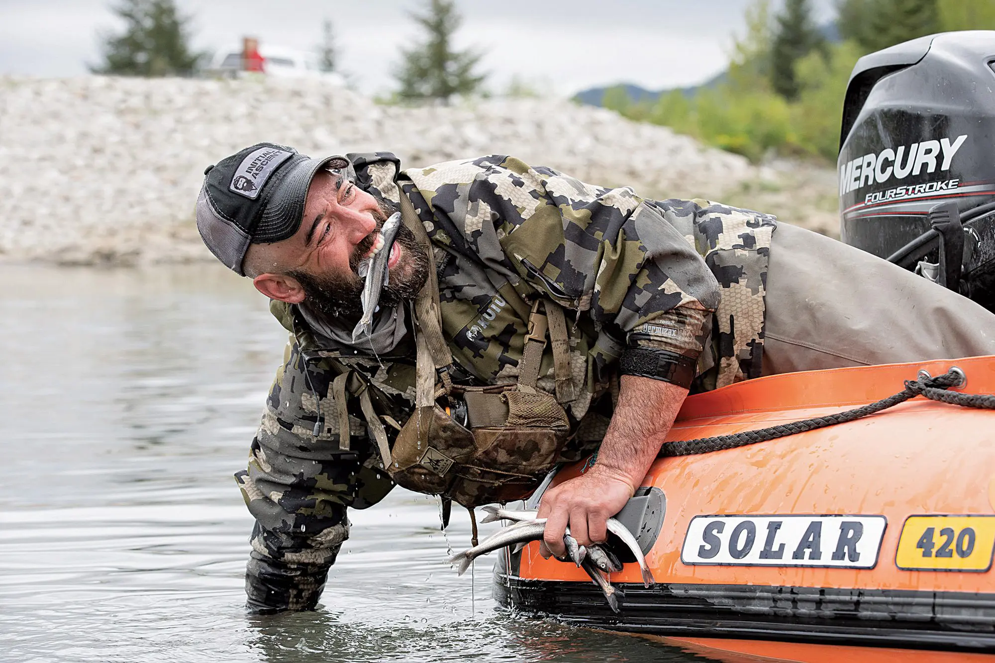 Steve Opat pulling fish out of the water