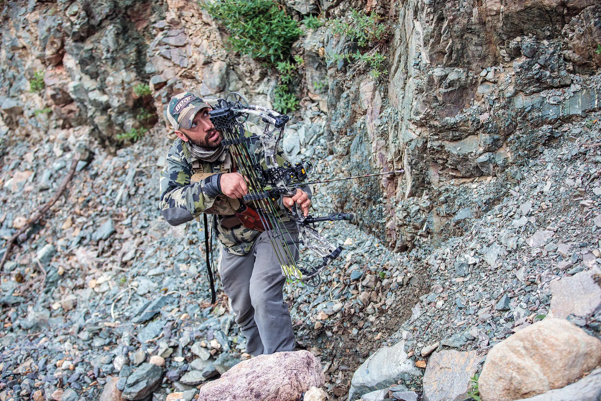 Steve Opat about to draw back his bow in the wilderness