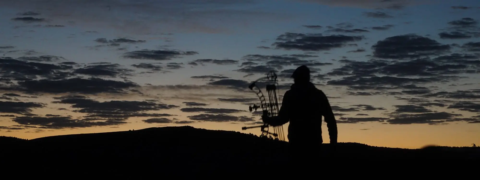 Remi Warren standing skylined on an archery antelope hunt.