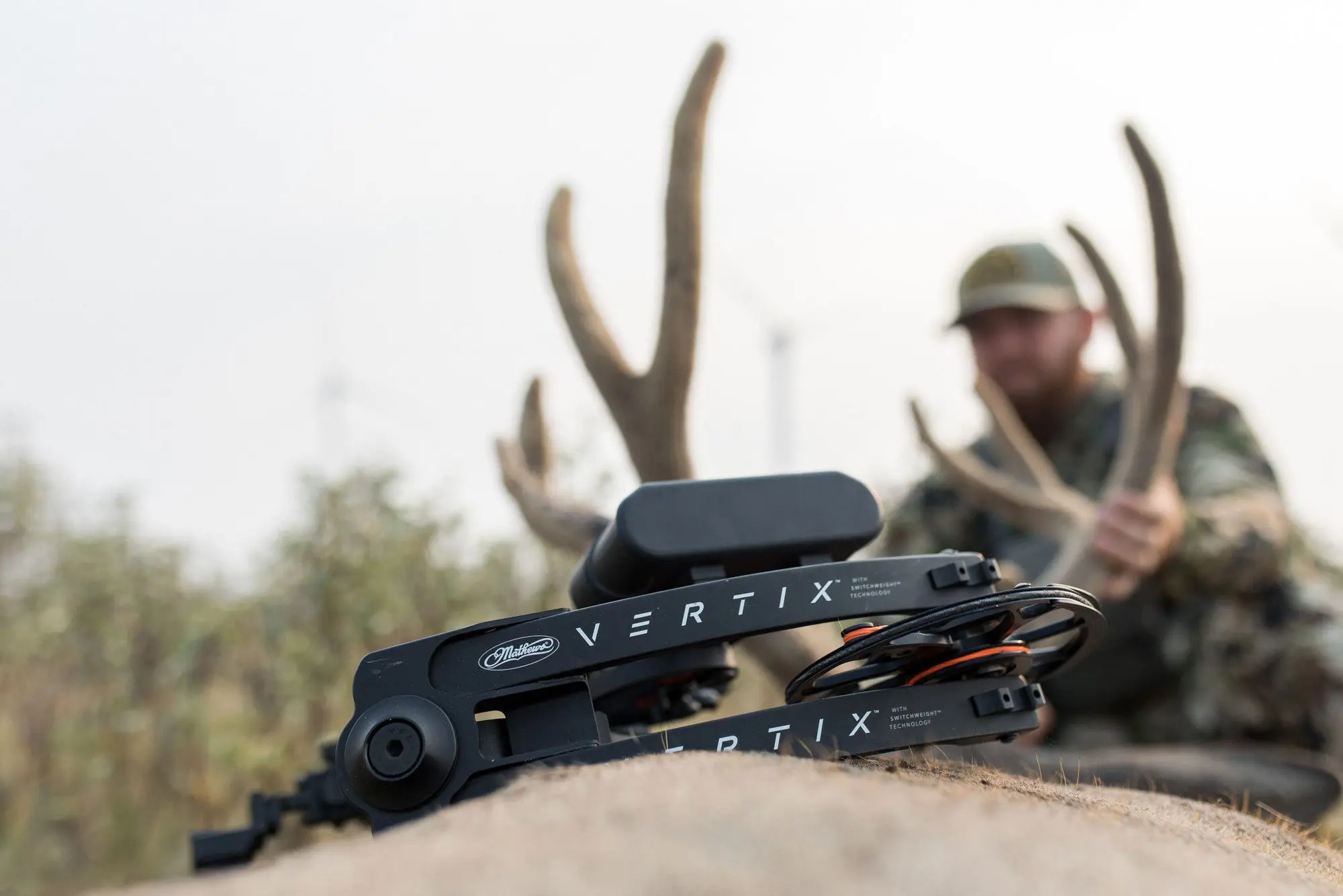 The Mathews Vertix laying on top of a mule deer buck.