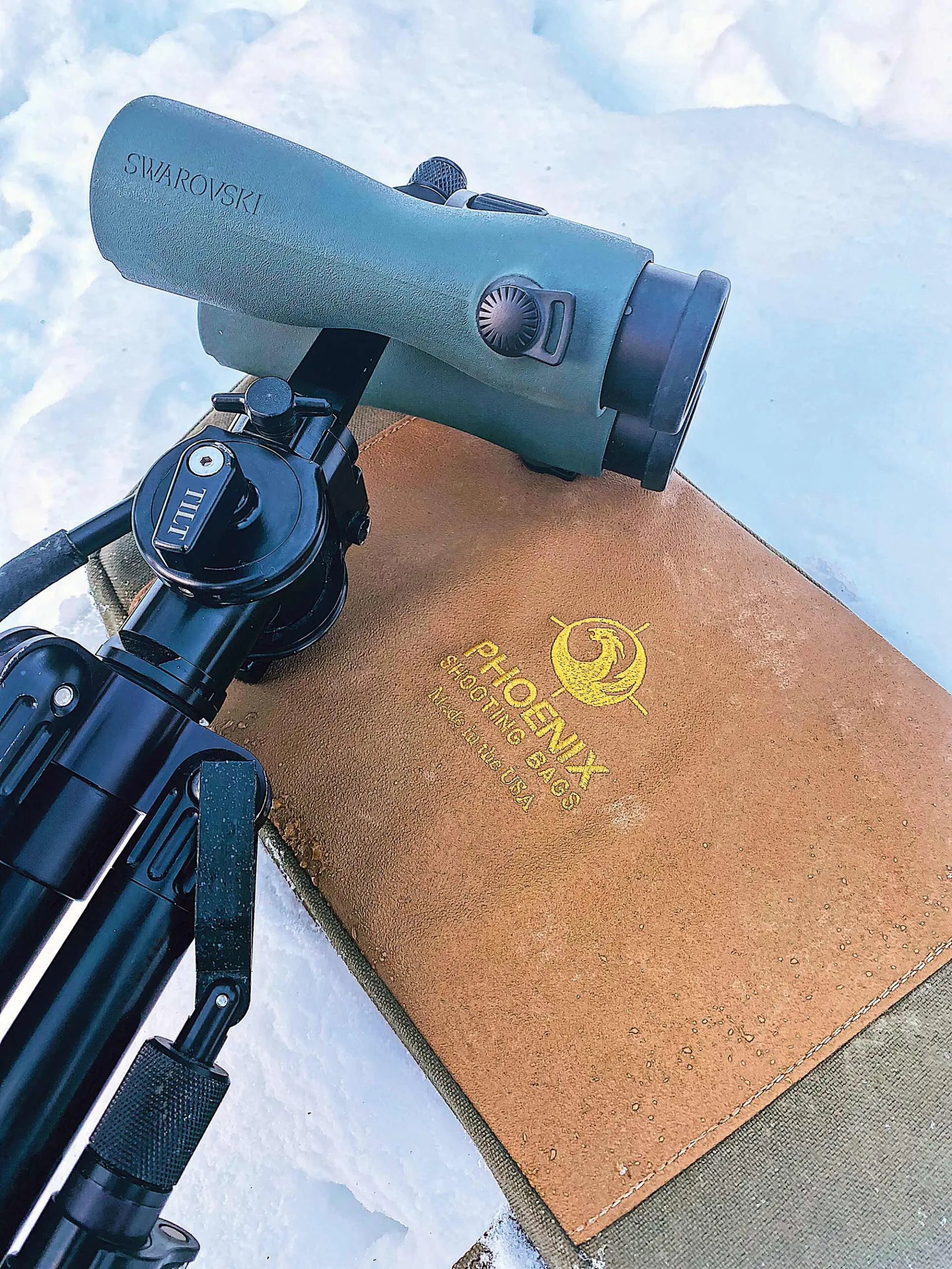 Phoenix Shooting Bags' Glassing Pad laid in snow with an Outdoorsmans Tripod