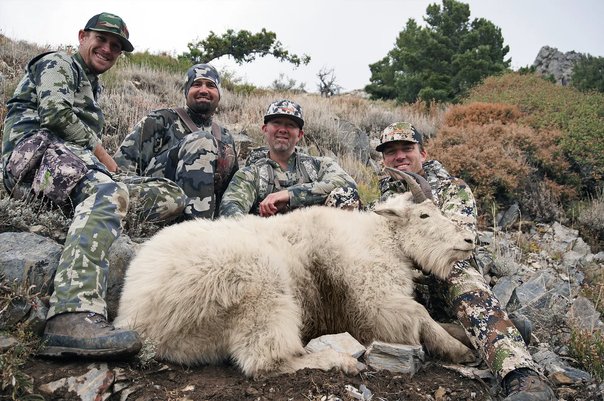 A grip and grip photo after a success Utah archery goat hunt.