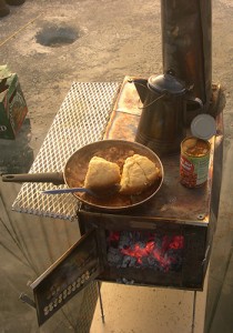 A wood stove set up in a Kifaru Tipi