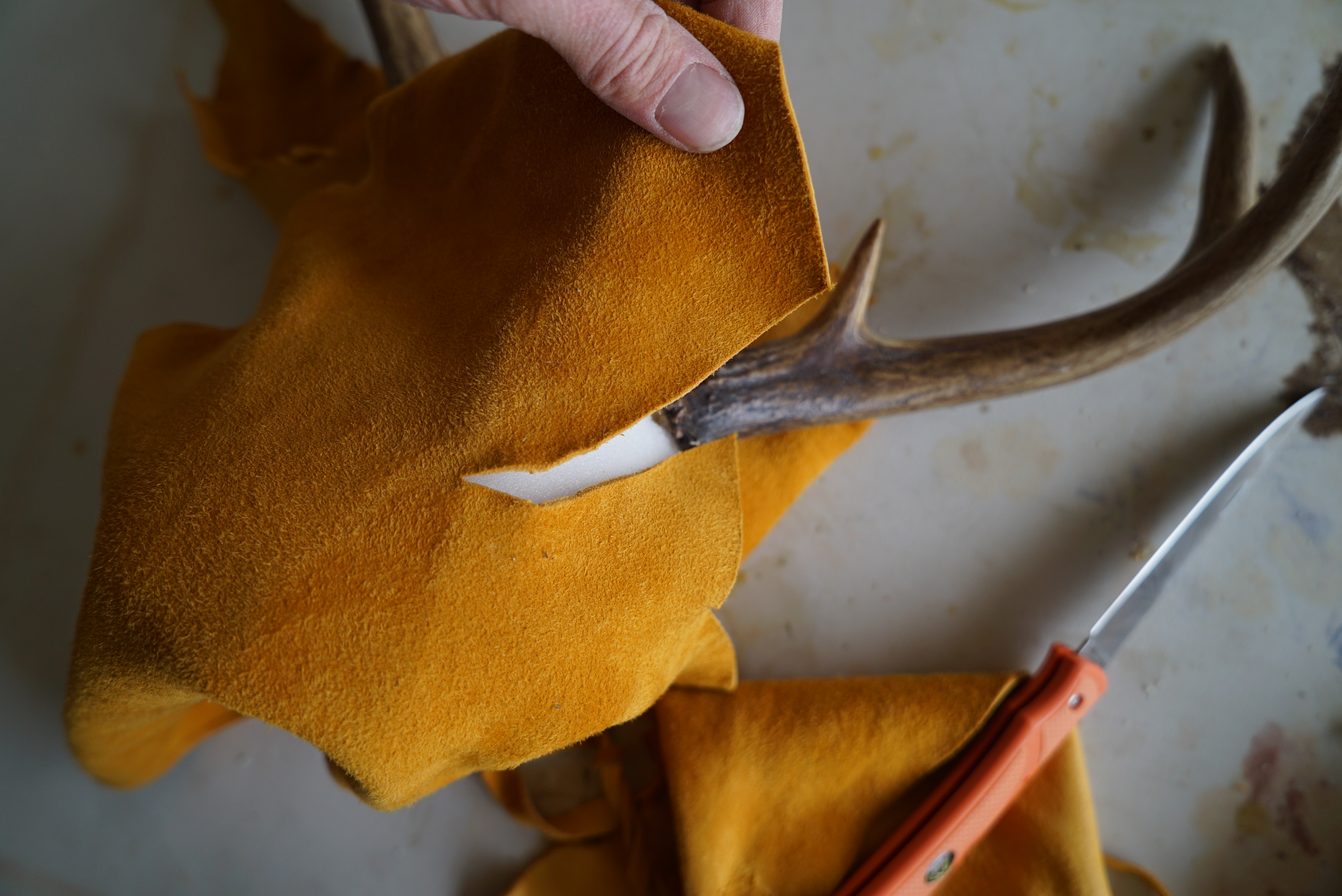 cut slits in the leather so it can fit around the horns.