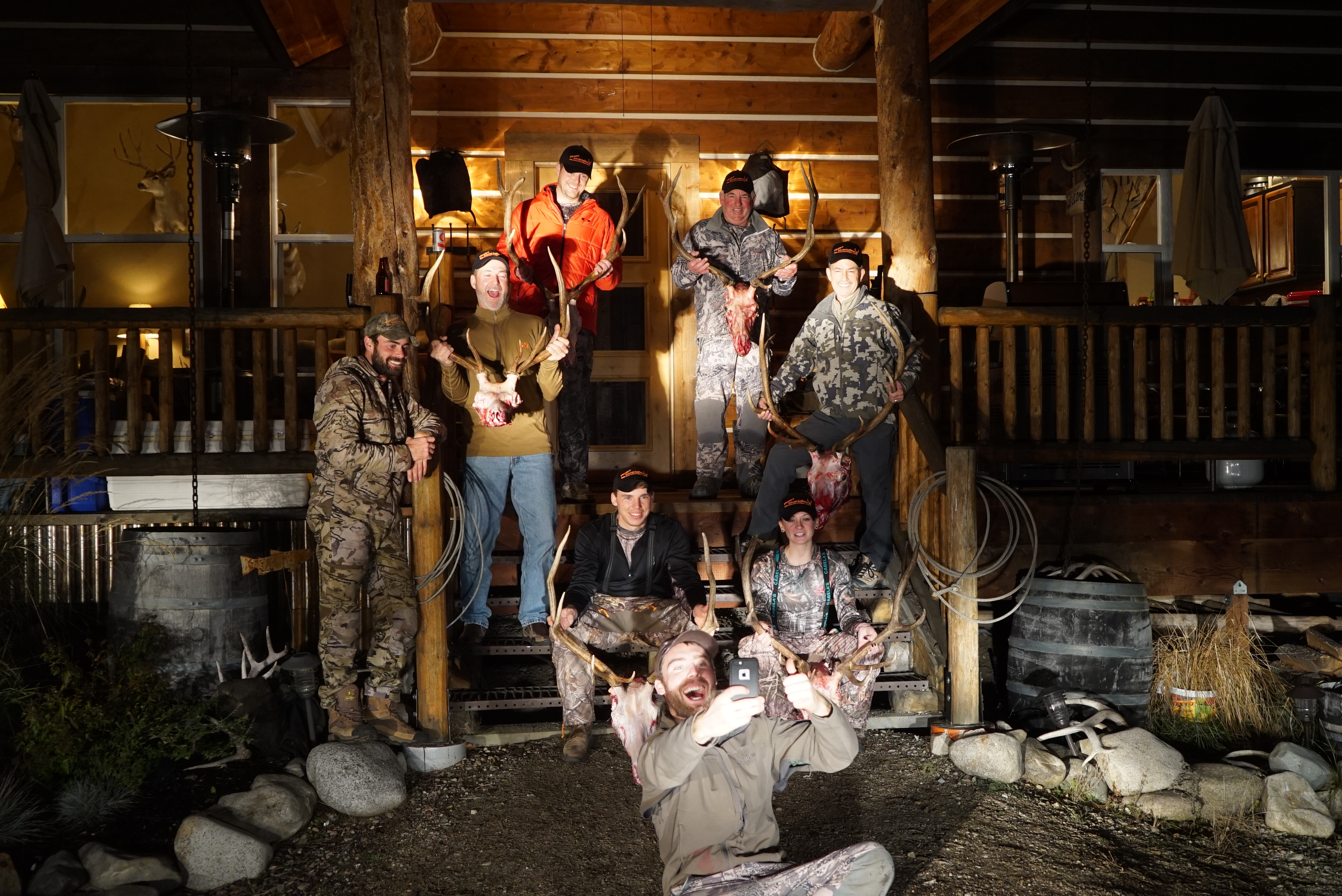 a group of hunters posing with their trophy and hunting guide