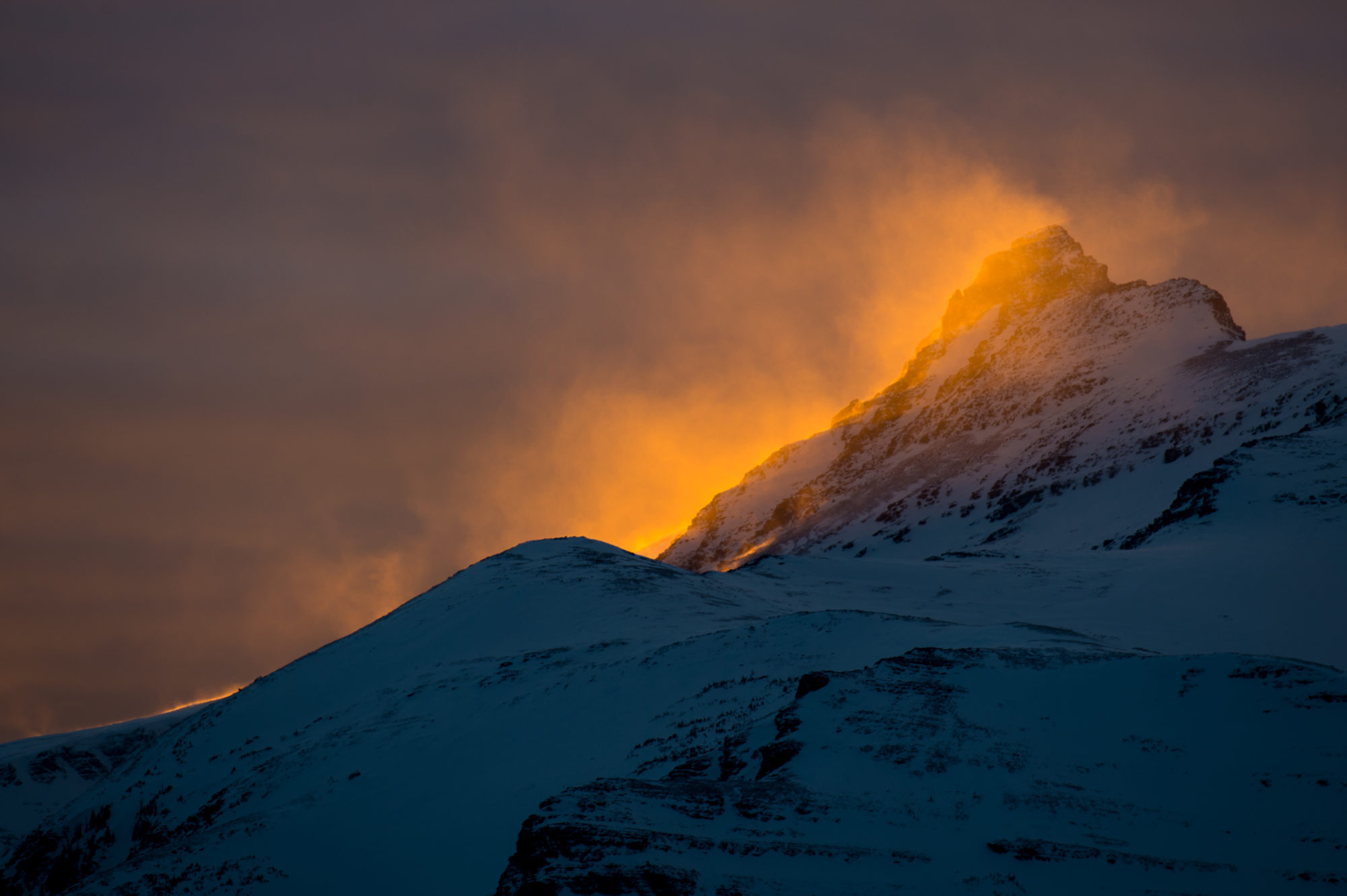 sun setting behind a peak offering a great opportunity for mountainscape photography