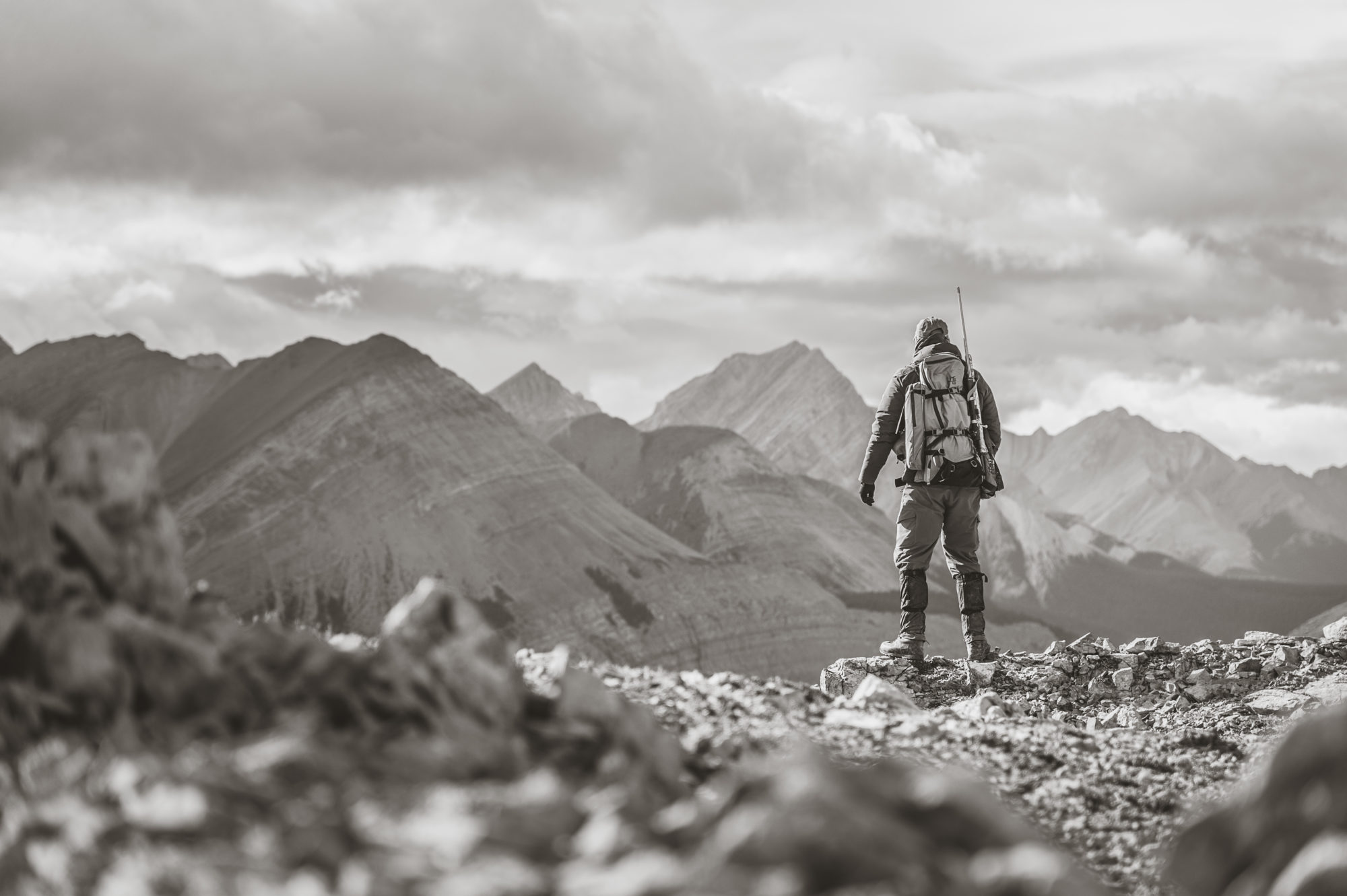 a hunter posing for mountainscape photography