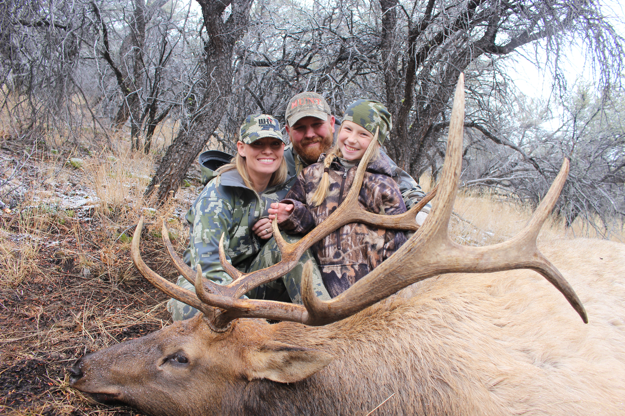 Zack and his family with a bull they shot in a new elk habitat.