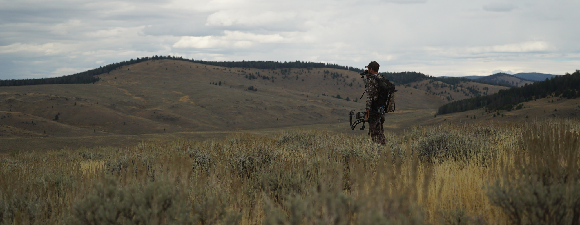 Hunter standing in a field on an archery antelope hunt.