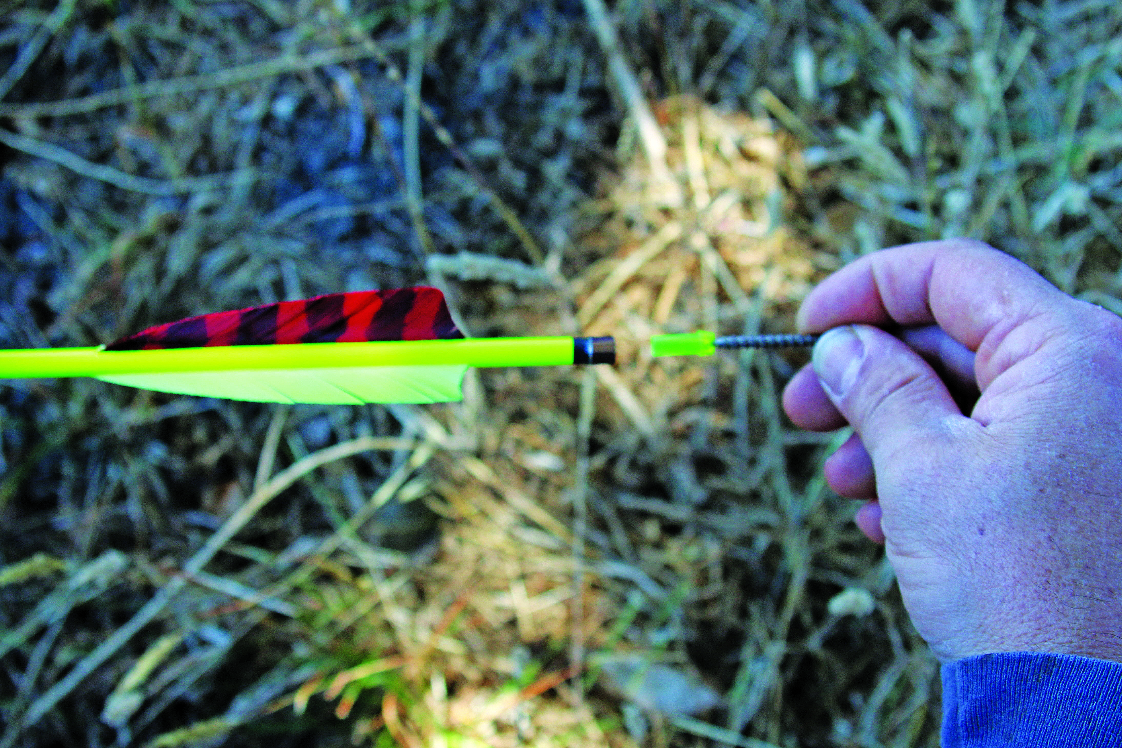 repairing an arrow in the field