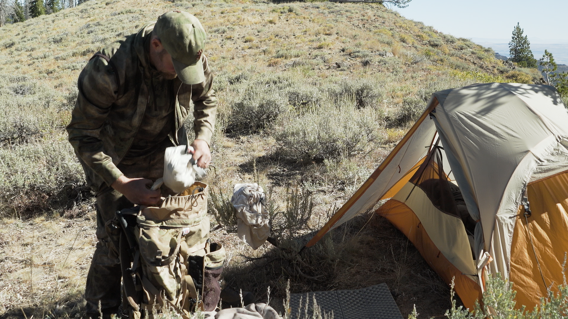 Nate packing all the items from his hunting gear list into his pack.