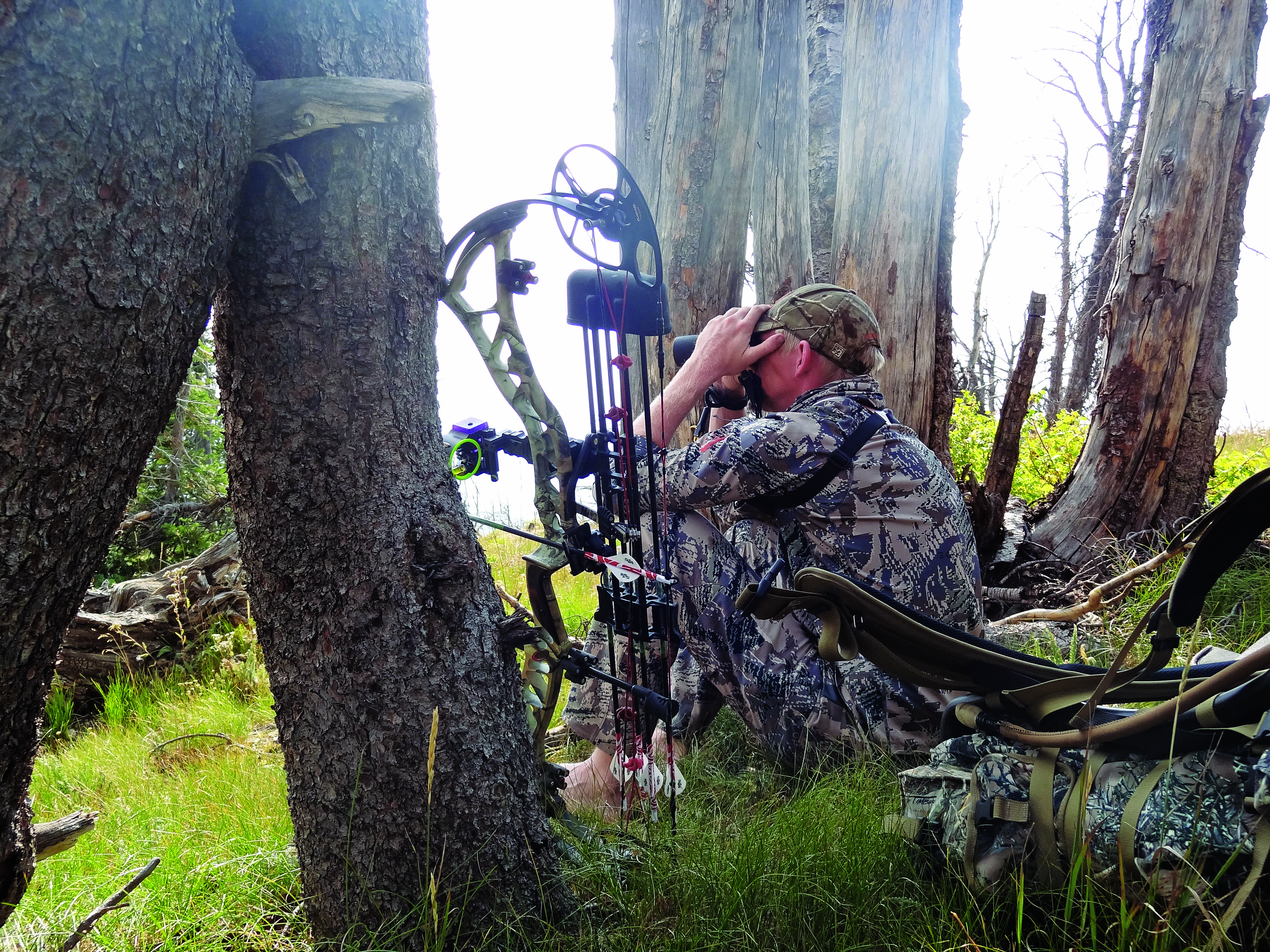 Glassing during a spot-and-stalk hunting with a bow.