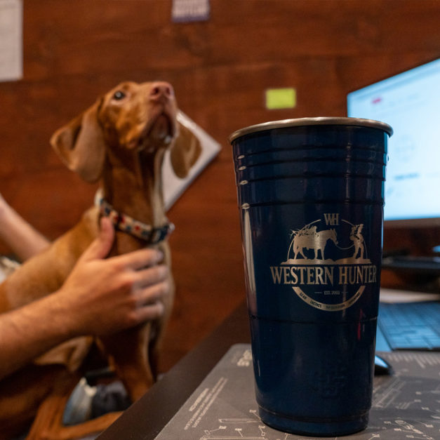 Lifestyle image of the Western Hunter blue cup on a desk